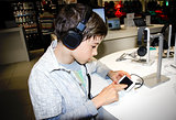 Portrait of a sweet young boy listening to music on headphones 