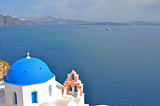white church with blue dome on greek santorini island, greece