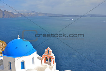 white church with blue dome on greek santorini island, greece