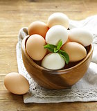 natural organic eggs in a wooden bowl