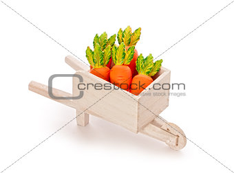 orange toy carrot in a wooden shopping cart with Clipping Path