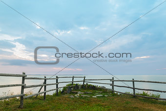 Wooden fence on ocean shore in the morning