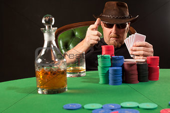 Poker player wearing sunglasses and hat