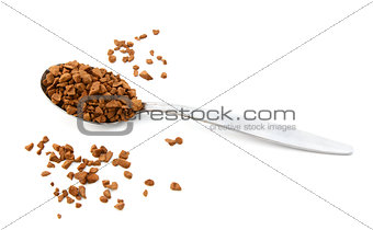 Teaspoon of instant coffee, some granules spilled 
