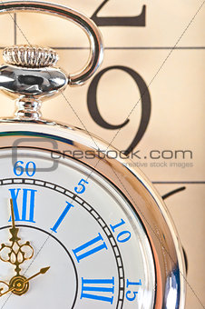 part of a pocket watch lying on the calendar