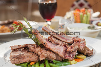 A la carte lamb chop meal on patterned plate