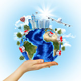 Woman hand hold Earth with buildings and airplane