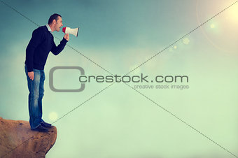 man with megaphone shouting from cliff edge