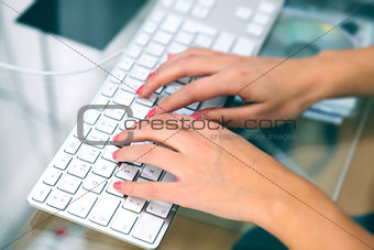 Woman Typing in her Laptop