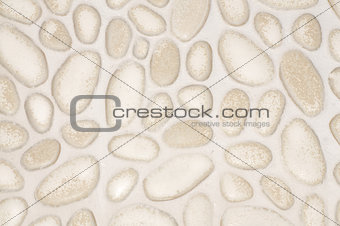 textured stone wall background with small stones and cement 