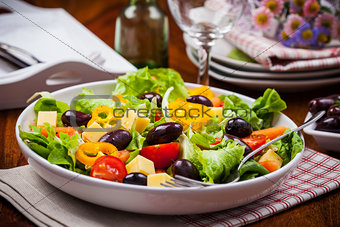 Vegetable salad with olives and cheese