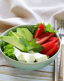 salad in asian style with tofu cheese, avocado and tomato