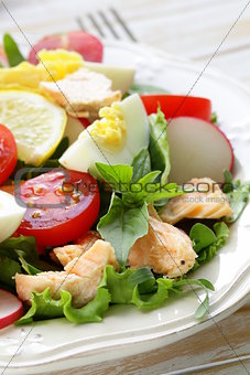 fresh green salad with salmon, egg and tomatoes