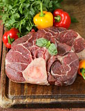 fresh raw meat ossobuco on a wooden board