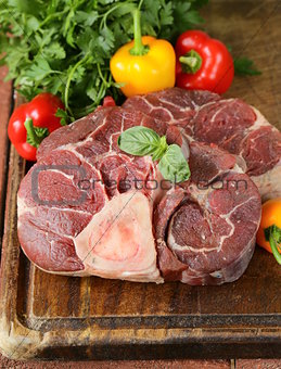 fresh raw meat ossobuco on a wooden board