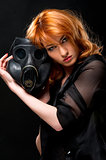 Redhead woman holding gas mask