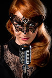Gorgeous redhead woman with retro microphone 
