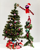 Christas characters decorating  Christmas tree, hanging star.