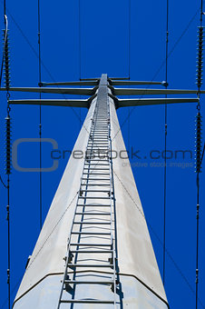 Looking up ladder on electrical tower