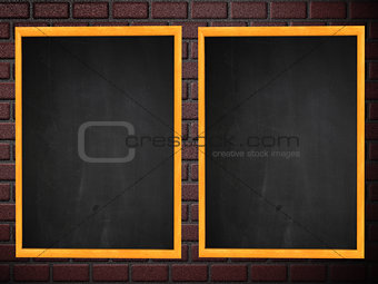 Two chalkboards on brick wall