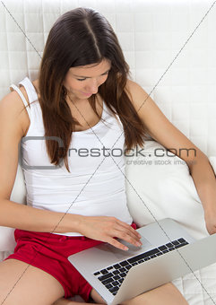 Young woman with new modern popular laptop typing keyboard 