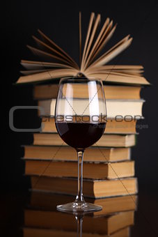 Wine glass and books