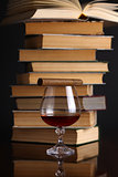 Glass of brandy and books