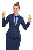 Smiling business woman making finger quote marks