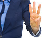 Closeup on business woman showing 3 fingers