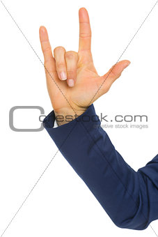 Closeup on business woman showing i love you gesture