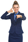 Business woman calling with hand gesture and pointing in camera
