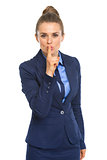 Business woman showing shh gesture