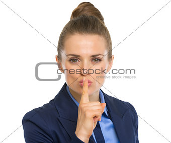 Portrait of business woman showing shh gesture
