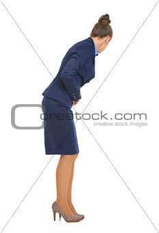 Full length portrait of business woman with stomach ache