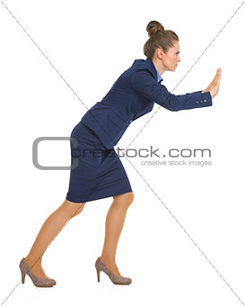 Full length portrait of business woman pushing something in fron