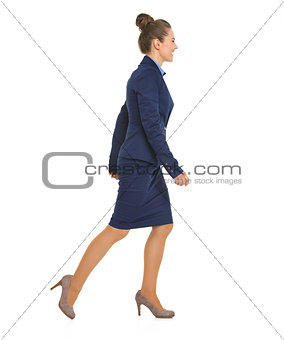 Full length portrait of business woman going sideways