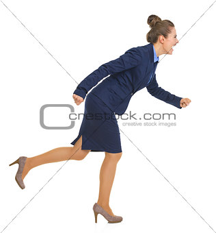 Full length portrait of smiling business woman running