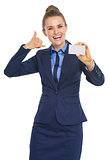 Portrait of smiling business woman showing business card and cal