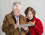 Shocked Couple with Tablet