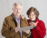 Startled Couple with Tablet