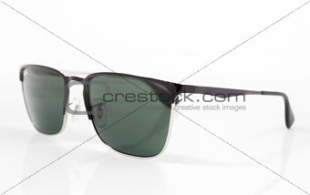 Green lens sunglasses isolated on white background