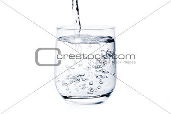 filling a glass with pure water and bubbles 