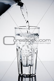 filling a glass with water showing a drink concept