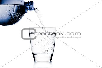 filling a glass with water trough blue bottle and space for text