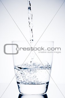 begin filling a glass with pure water and bubbles