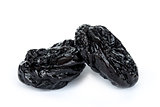 Close up of pitted prunes isolated on white background