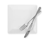 White dinner plate and cutlery isolated on white background.