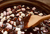 Mixing mini marshmallows into dark chocolate