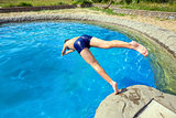Teenager jumping into pool