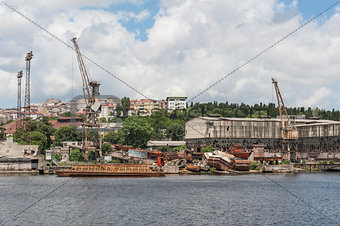 Derelict dockyard by river in city